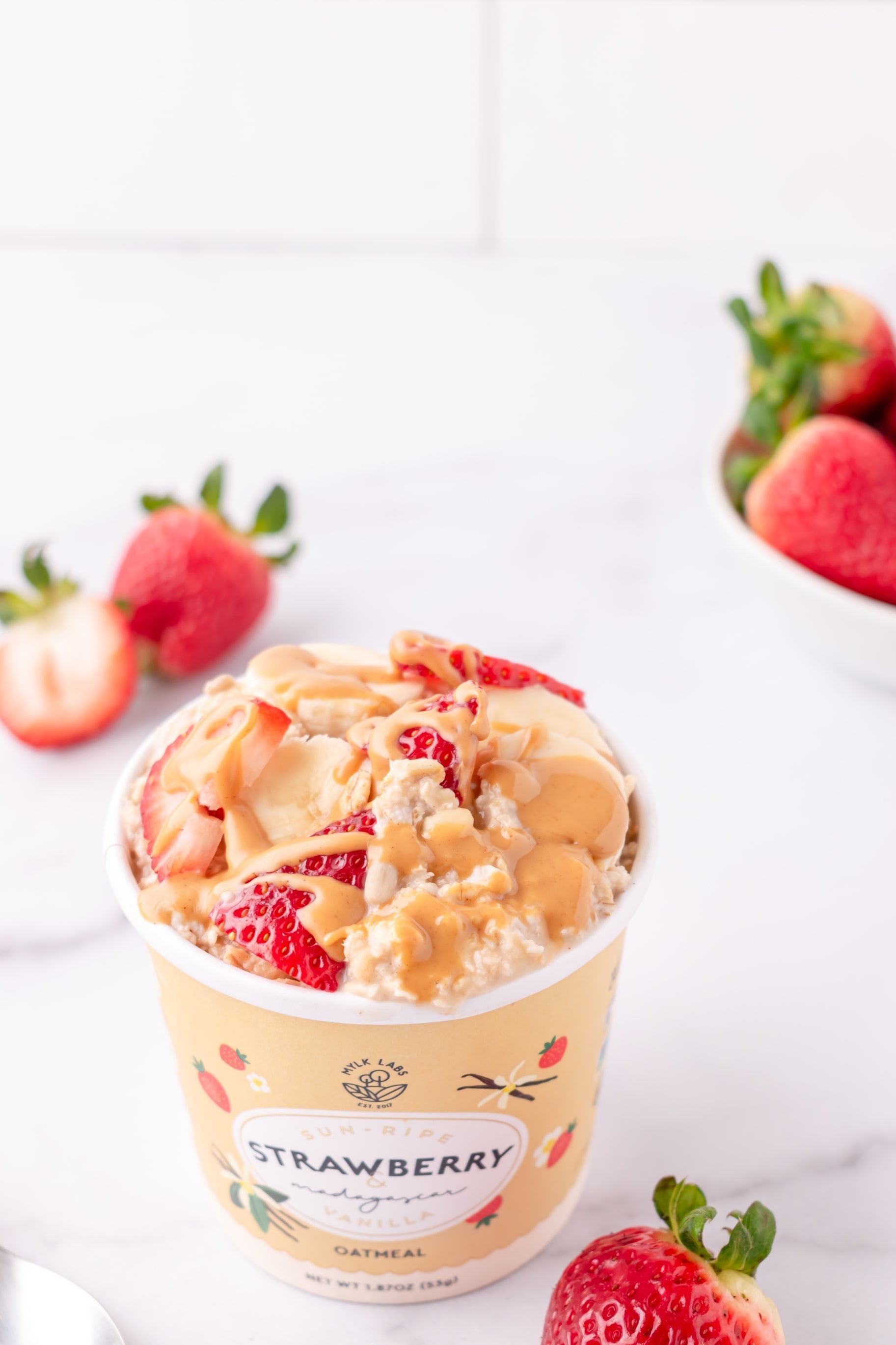 strawberry instant oatmeal with fruit and peanut butter drizzle