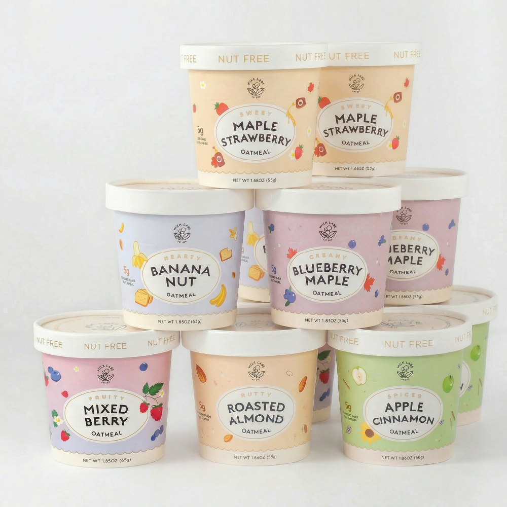Assorted containers of oatmeal with colorful labels on a white background