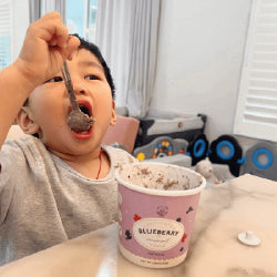 A child eating oatmeal with a spoon