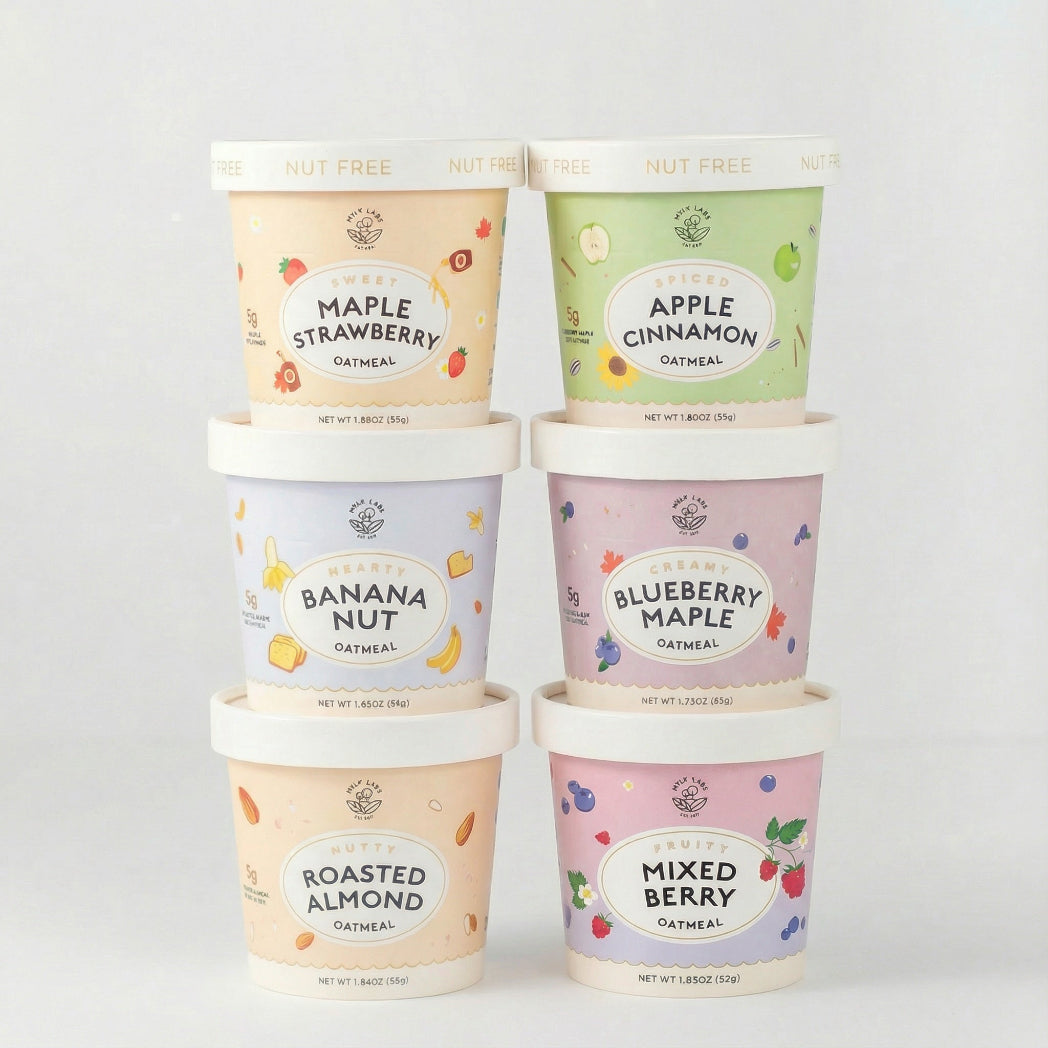 Six containers of oatmeal with different flavors on a white background