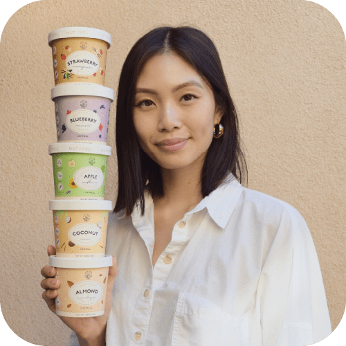 woman holding a stack of oatmeal cups