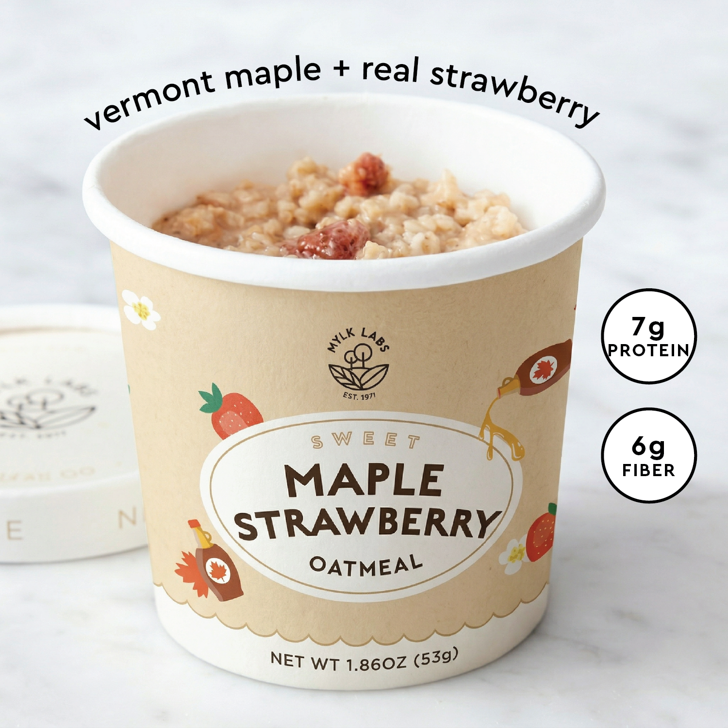 A cup of Mylk Labs Sweet Maple Strawberry Oatmeal, shown open with the oatmeal and strawberries visible. The kraft paper cup has illustrations of strawberries and flowers, and text on the image reads 'vermont maple + real strawberry' along with nutrition badges showing 7g protein and 6g fiber.