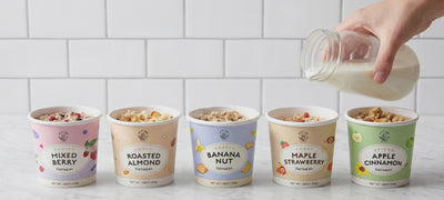 pouring milk into various flavors of oatmeal cups
