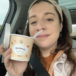 a woman in the car eating oatmeal
